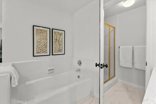 a bathroom with a bathtub and shower