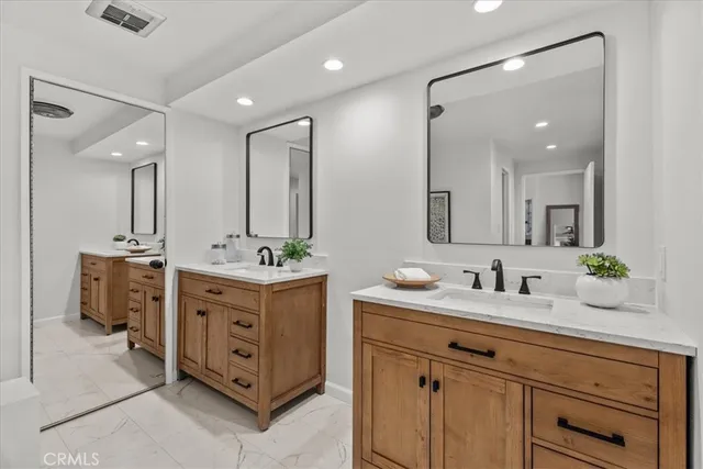 a bathroom with a double vanity sink mirror and double