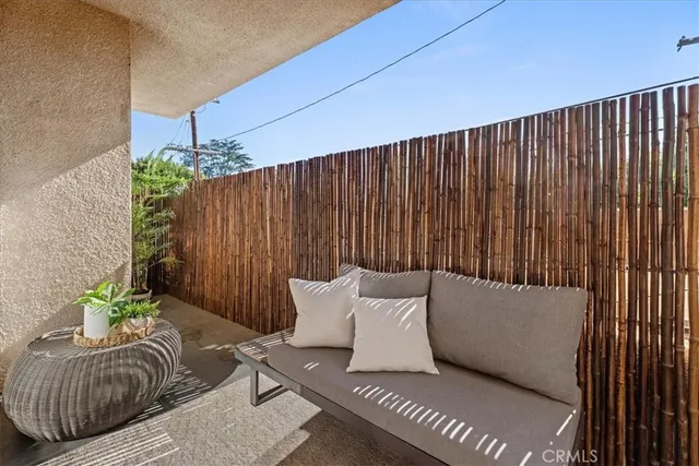 a balcony with furniture and a potted plant