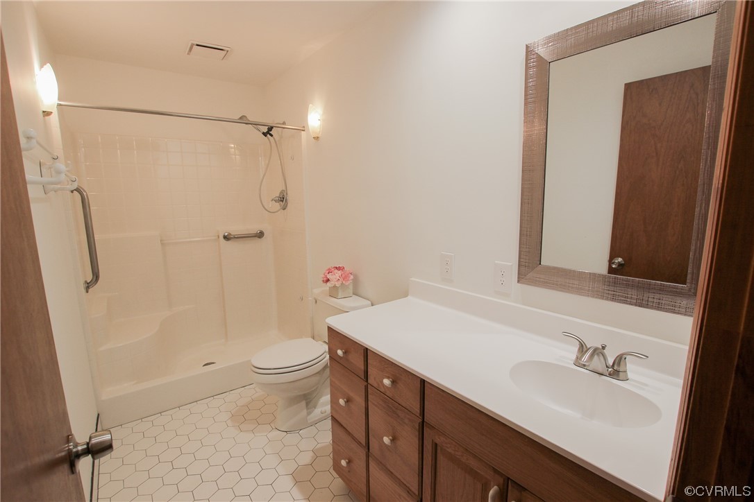 1120 Mill Road King William, VA 23086 - Photo 14 of 40 a bathroom with a sink a toilet and shower