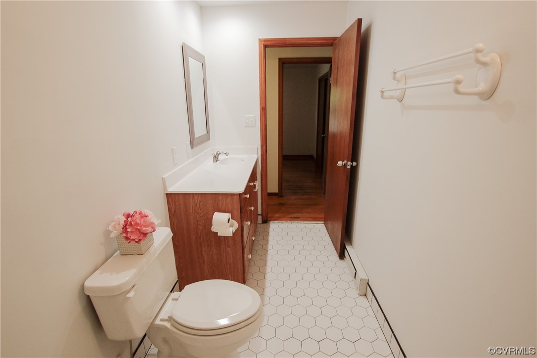 1120 Mill Road King William, VA 23086 - Photo 16 of 40 a bathroom with a toilet sink vanity and mirror