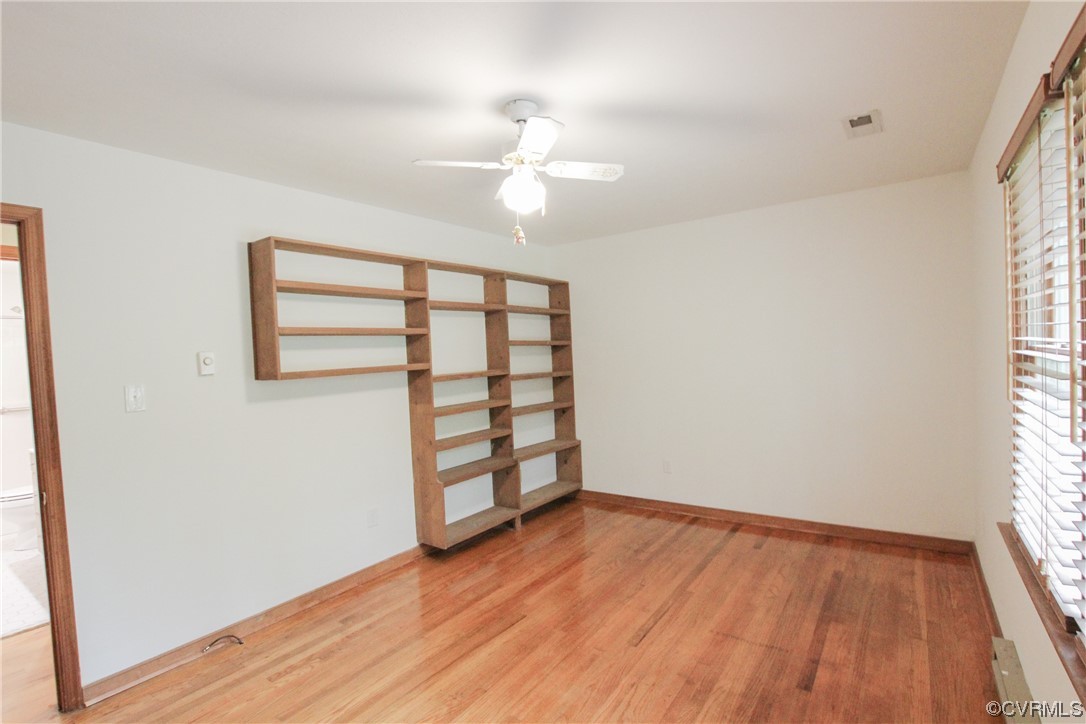 1120 Mill Road King William, VA 23086 - Photo 20 of 40 an empty room with wooden floor chandelier fan and windows
