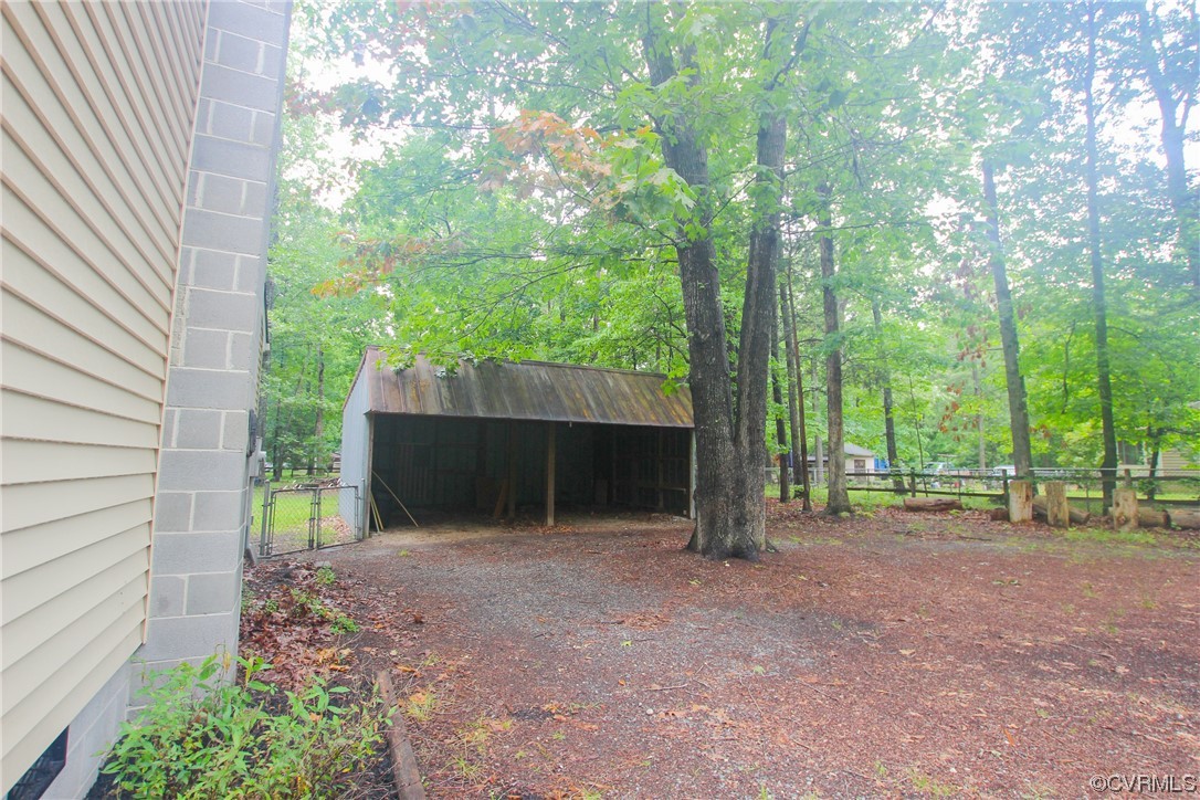 1120 Mill Road King William, VA 23086 - Photo 33 of 40 a view of a backyard with large trees and a barn
