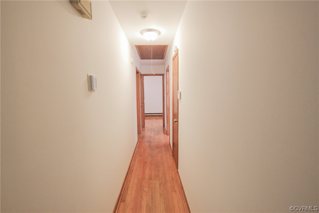 1120 Mill Road King William, VA 23086 - Photo 4 of 40 a view of a hallway with wooden floor and a bathroom