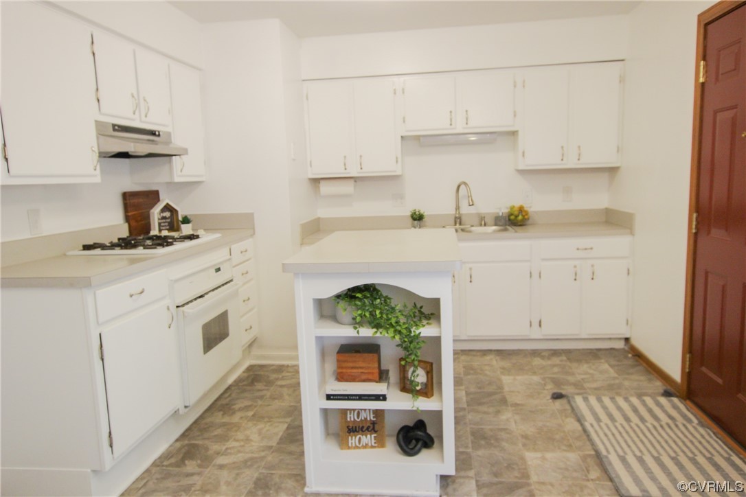 1120 Mill Road King William, VA 23086 - Photo 7 of 40 a kitchen with granite countertop white cabinets and white appliances