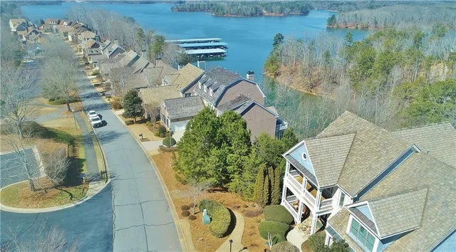 an aerial view of a house with a yard and large trees