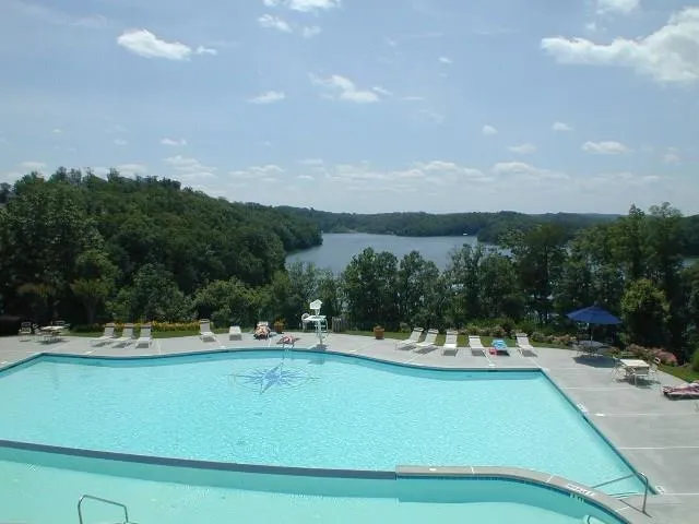 a view of a swimming pool with a yard and mountain view