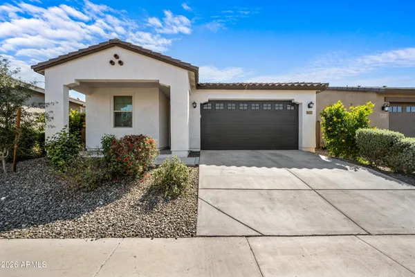a front view of a house with a yard and garage