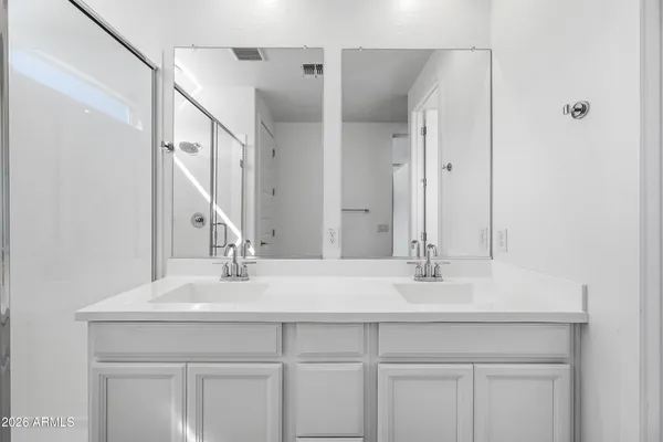 a bathroom with a shower sink and a mirror