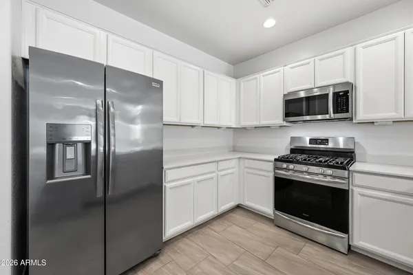 a kitchen with kitchen island a sink a counter space and stainless steel appliances