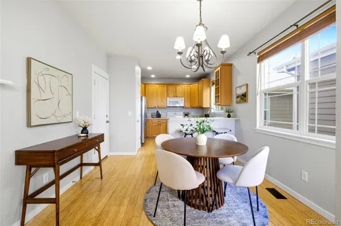 a view of a dining room with furniture and a chandelier