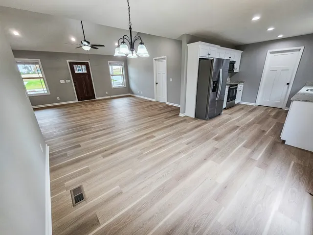 a view of a hallway with wooden floor