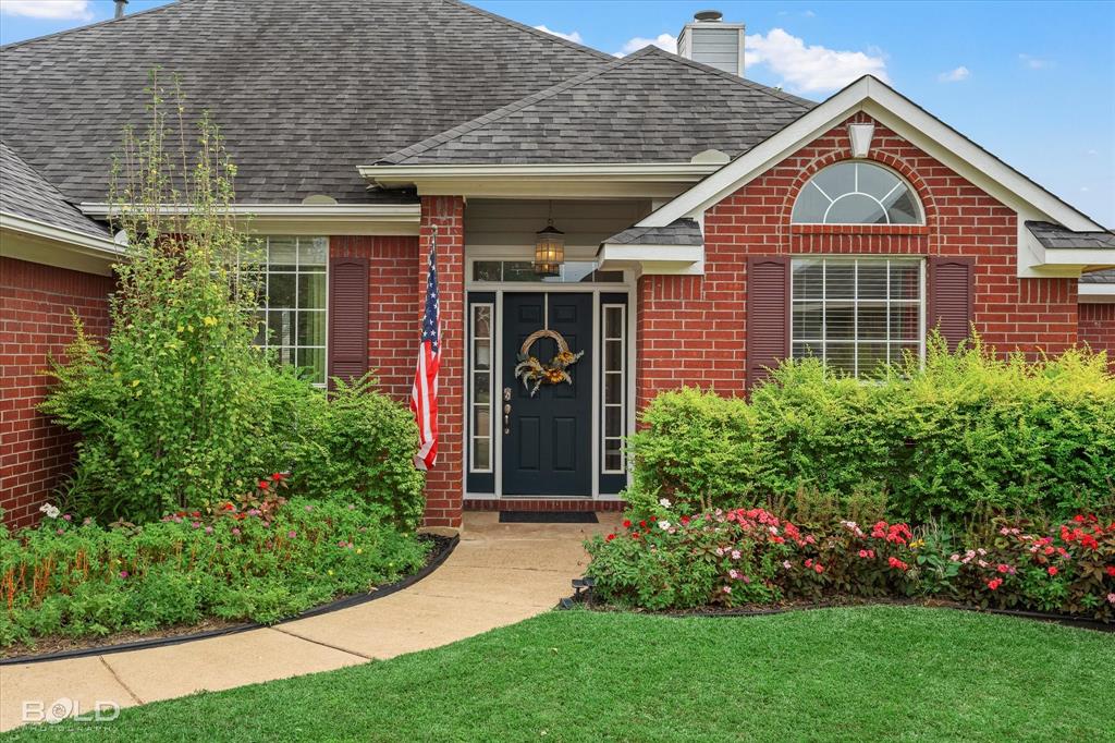 6020 Applegate Circle Bossier City, LA 71111 - Photo 2 of 36 a front view of a house with a garden