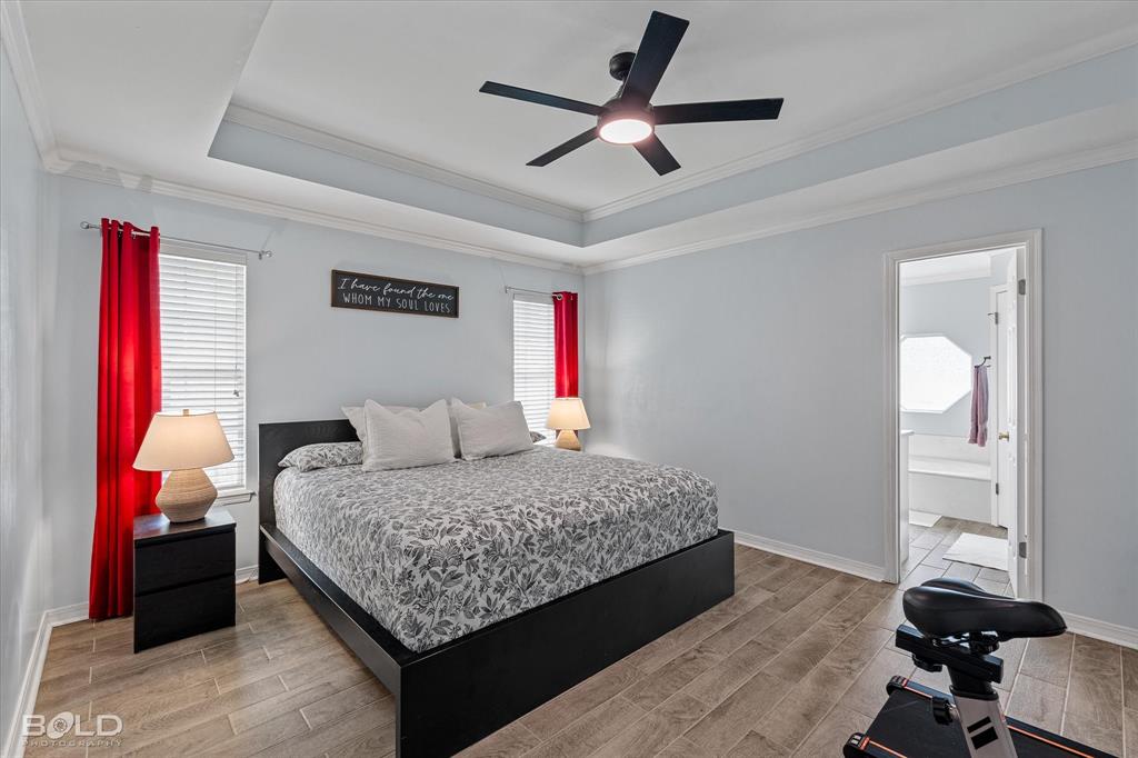 6020 Applegate Circle Bossier City, LA 71111 - Photo 26 of 36 a bedroom with a bed and a chandelier