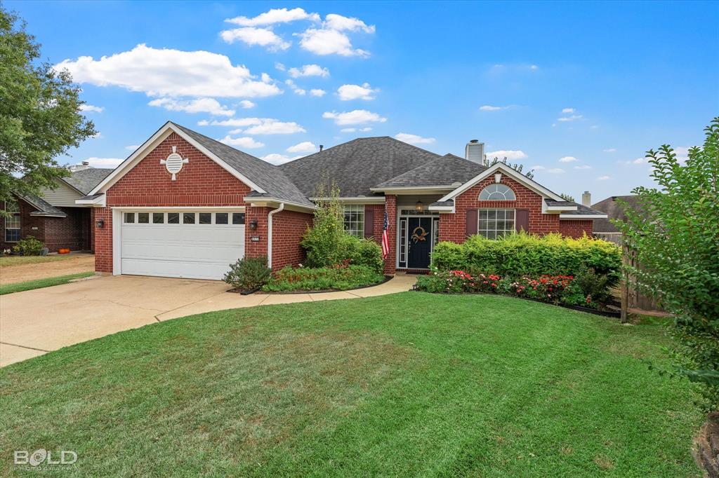 6020 Applegate Circle Bossier City, LA 71111 - Photo 3 of 36 a front view of a house with a garden and garage