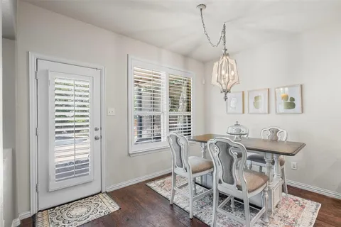 a view of a dining room with furniture and chandelier