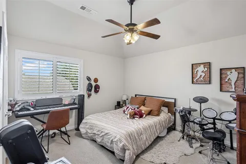 a bedroom with bed and a window
