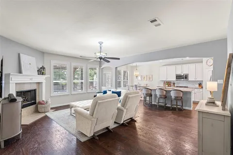 a living room with furniture fireplace and window