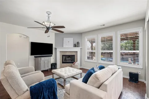 a living room with furniture a fireplace and a flat screen tv