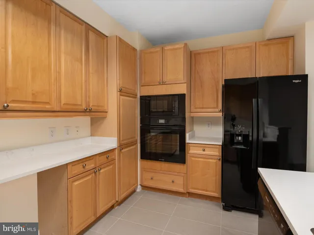 a kitchen with a refrigerator and cabinets