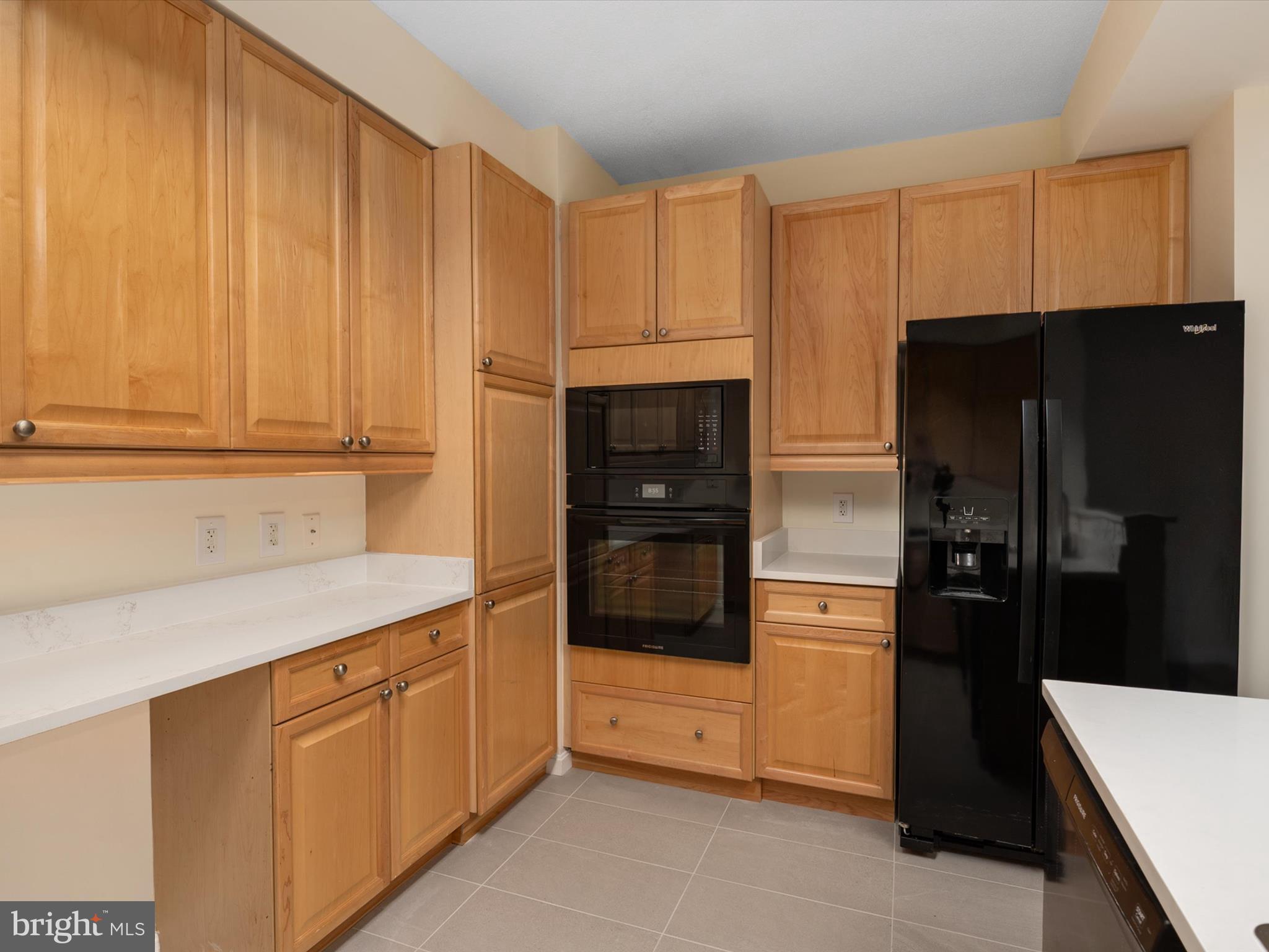 940 Astern Way, Unit 604 Annapolis, MD 21401 - Photo 14 of 27 a kitchen with a refrigerator and cabinets