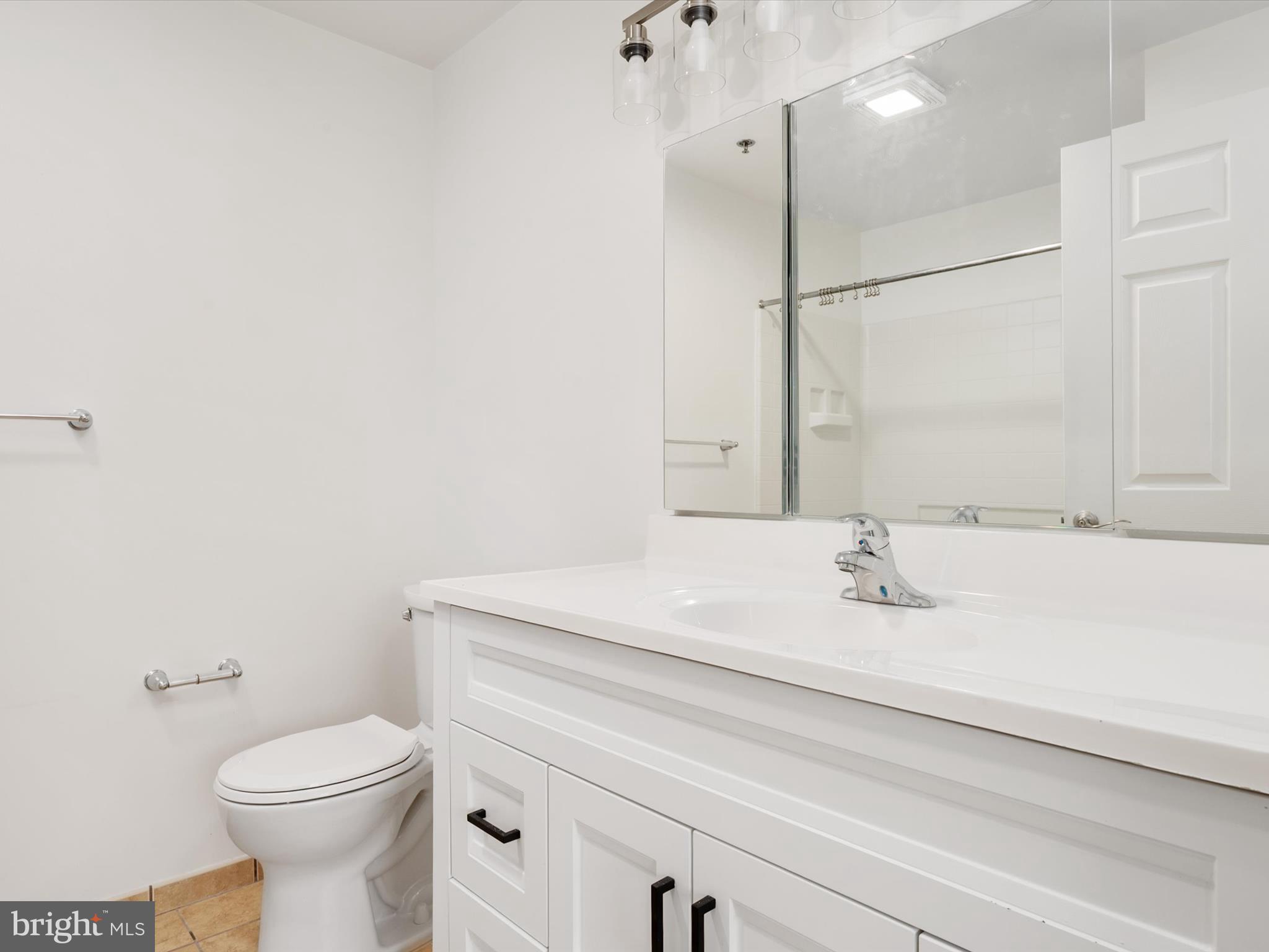 940 Astern Way, Unit 604 Annapolis, MD 21401 - Photo 17 of 27 a bathroom with a sink a toilet and a mirror