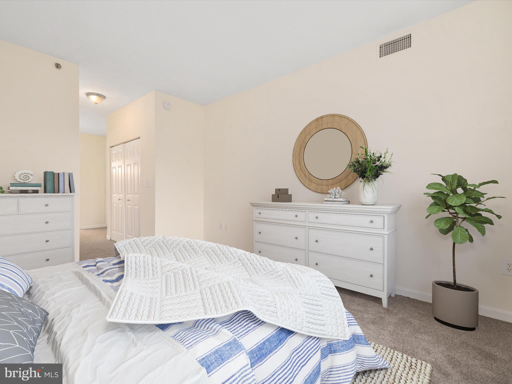 940 Astern Way, Unit 604 Annapolis, MD 21401 - Photo 21 of 27 a bedroom with a bed and a potted plant