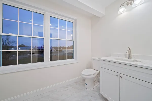 a bathroom with a toilet sink and mirror