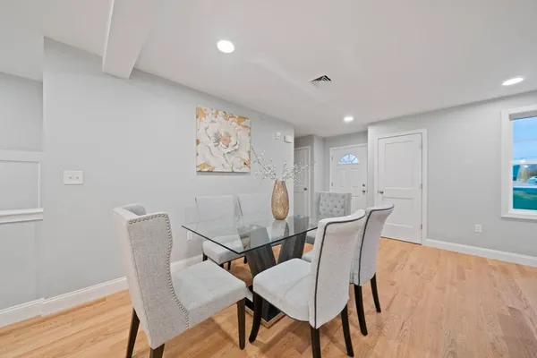 a view of a dining room with furniture and wooden floor