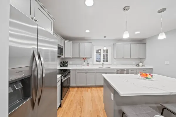 a kitchen with a sink stainless steel appliances and cabinets