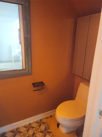 a bathroom with a toilet and a window