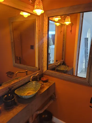 a bathroom with a double vanity sink and a mirror