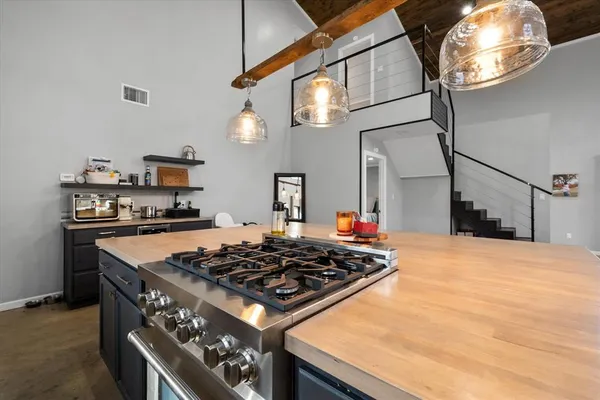 a stove top oven sitting inside of a kitchen