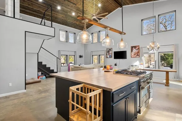a open kitchen with stainless steel appliances granite countertop a stove and a refrigerator