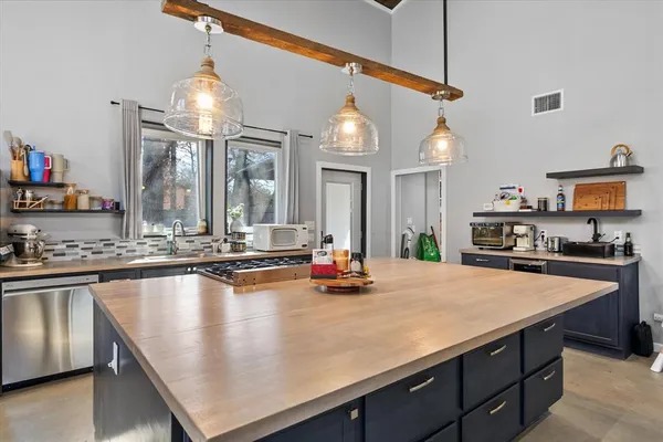 a kitchen with sink and chairs