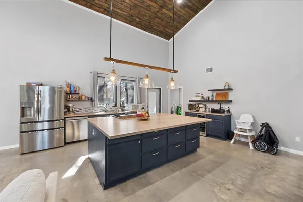 a kitchen with stainless steel appliances granite countertop a sink counter space and cabinets