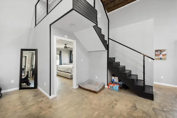 a view of a livingroom with furniture and stairs