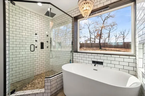 a bathroom with a bathtub and a shower
