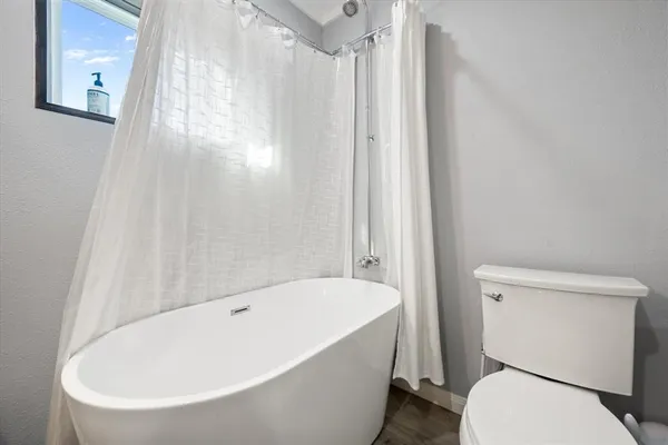 a white bath tub sitting next to a white toilet