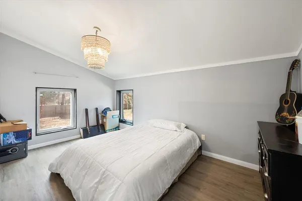 a bedroom with a bed and a painting on the wall