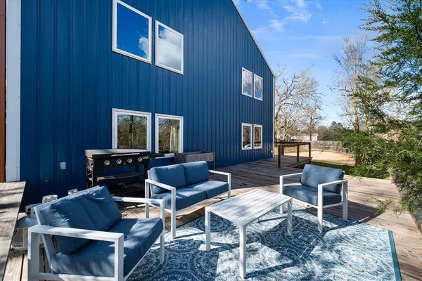 a backyard of a house with outdoor seating