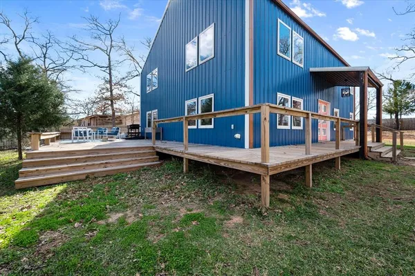 a wooden bench sitting in middle of a yard