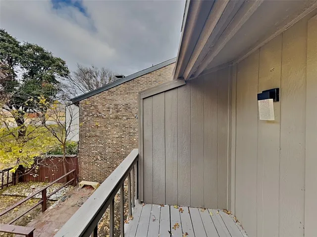 a view of balcony with wooden floor and stairs