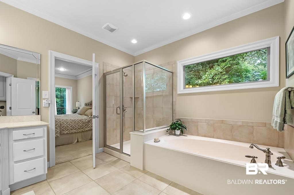 29976 Dolive Ridge Daphne, AL 36527 - Photo 34 of 58 Bathroom featuring vanity, crown molding, tile patterned flooring, and separate shower and tub