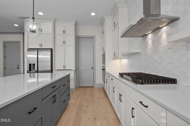 a kitchen with cabinets and window
