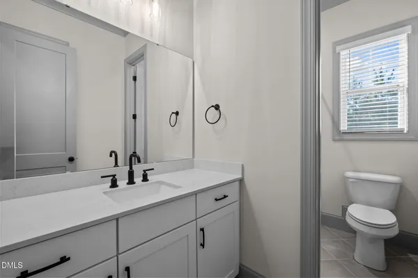 a bathroom with a toilet and a window