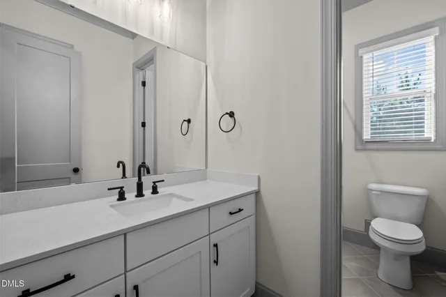 a bathroom with a toilet and a window