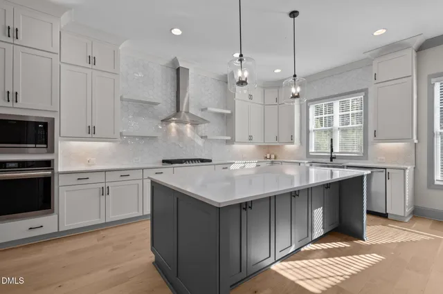 a kitchen with kitchen island granite countertop a sink cabinets and stainless steel appliances