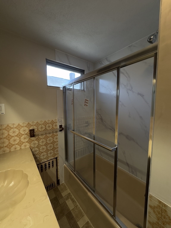 a bathroom with a shower and a sink