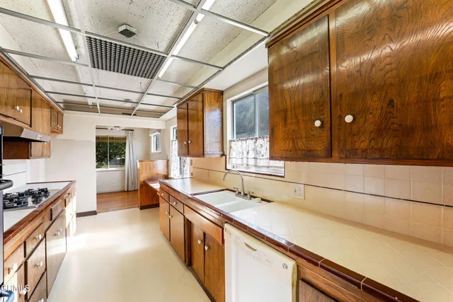 a kitchen with stainless steel appliances granite countertop a sink and cabinets